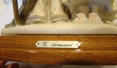 Marks; G. Armani plate on front of wood base, impressed 1982 Florence 